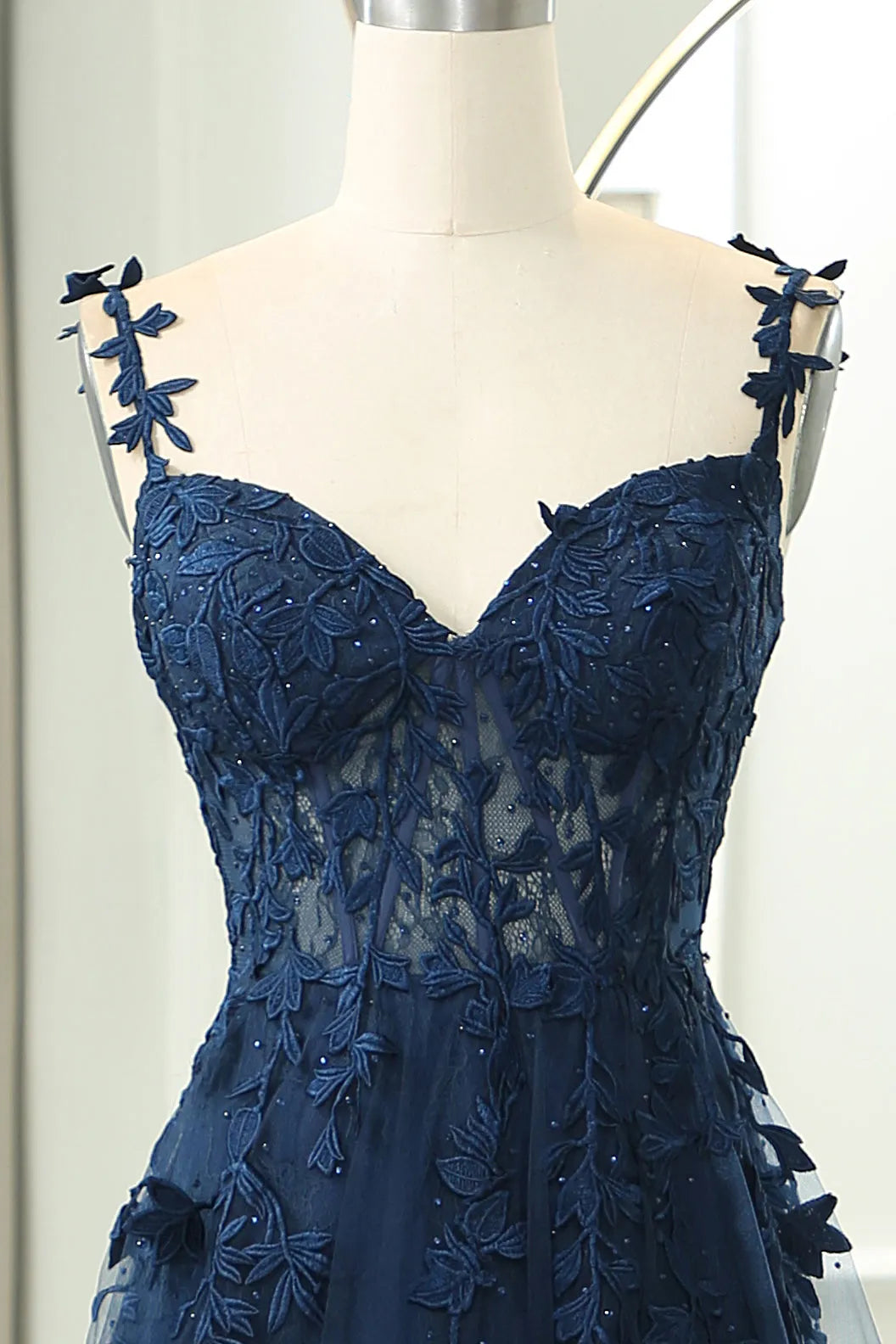 Close-up of the intricate appliques on the light blue prom dress.