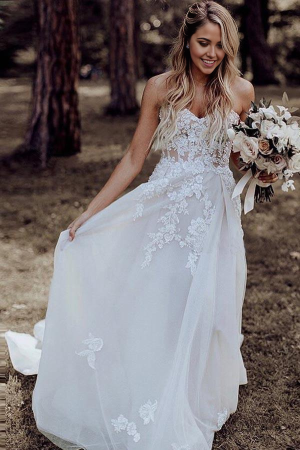 Front view of an elegant A-Line sweetheart wedding dress with appliques and beading.