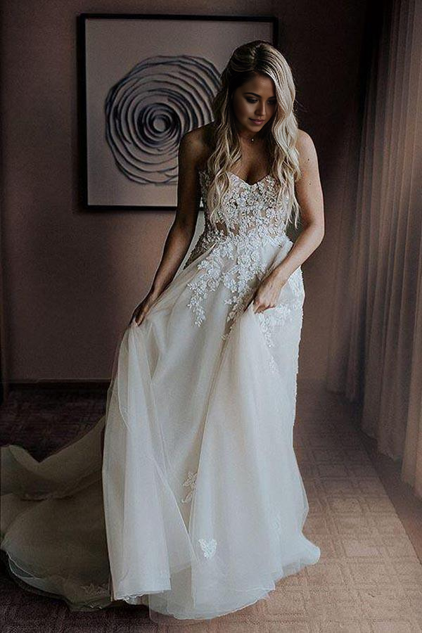 Side view of an A-Line sweetheart wedding dress with intricate appliques and beading.