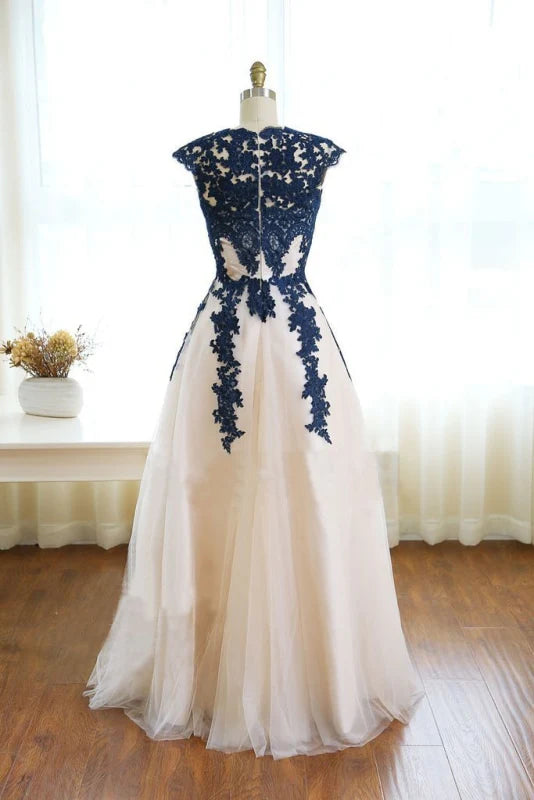 Full view of a woman in a floor-length elegant prom gown with delicate appliques.