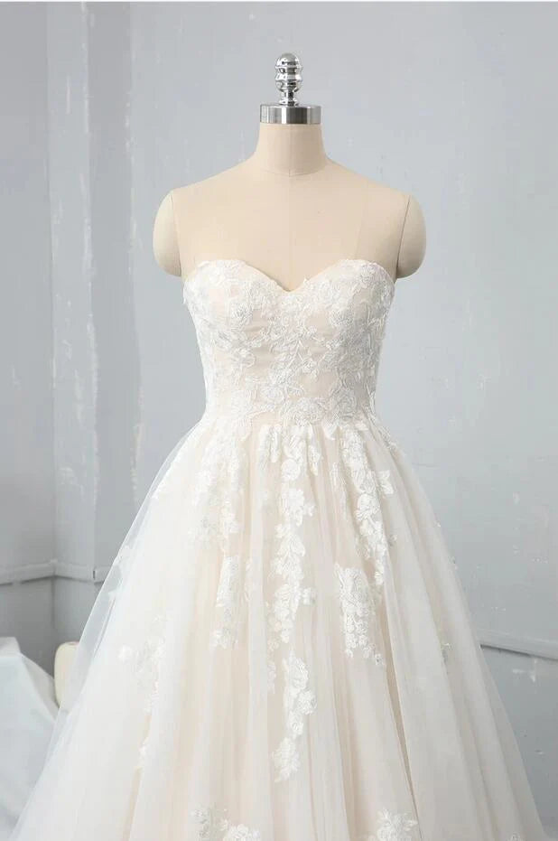 Close-up of lace appliques on a sweetheart wedding dress.