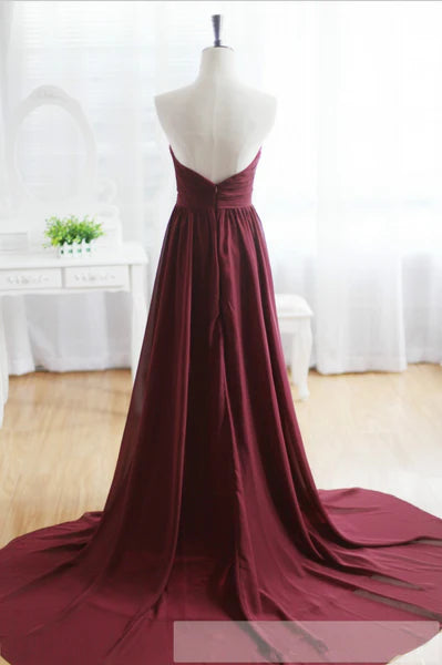 Close-up of the backless design and sweep train of the formal A-Line dress.