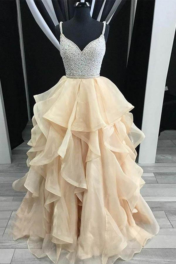 Elegant A-line prom dress with sweetheart neckline, spaghetti straps, tiered organza skirt, and intricate beading.