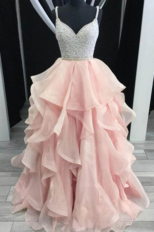 Back view of a tiered organza prom dress, showcasing the backless design and delicate beading.