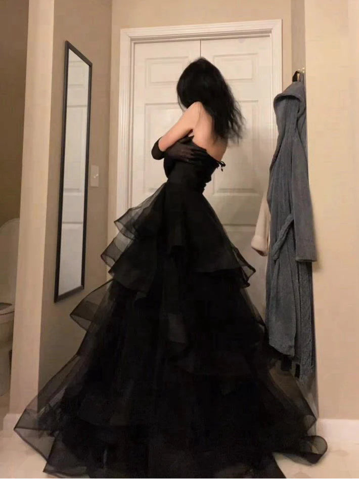 Full length view of a woman wearing an A-line sweetheart prom dress.