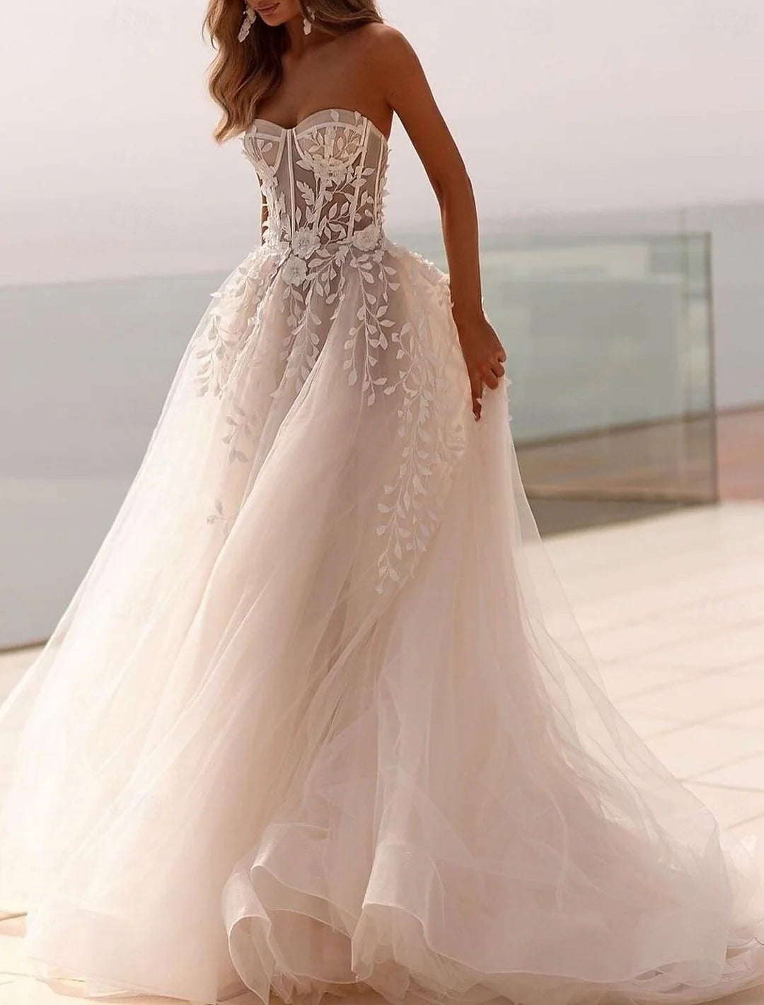 Elegant A-Line beach wedding dress with sweetheart neckline and sweep train.