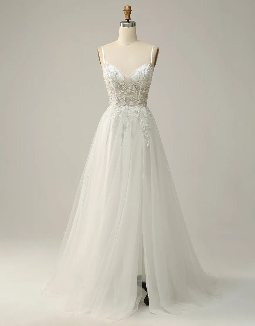Model wearing an elegant A-line maxi prom dress with delicate beading and spaghetti straps.