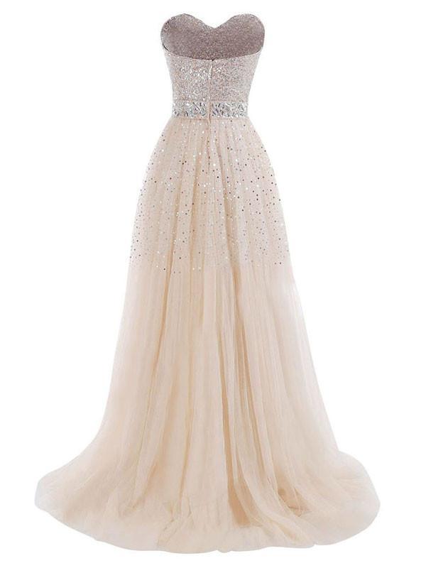 Side view of a long tulle prom dress, showcasing its flowing silhouette.