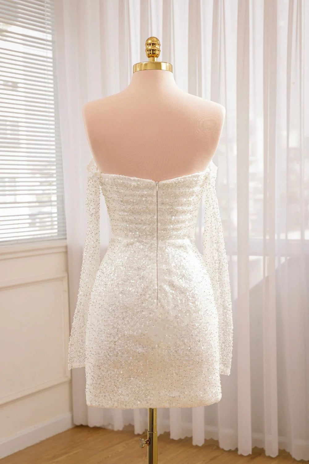 Full length view of the short wedding dress with long detachable sleeves.