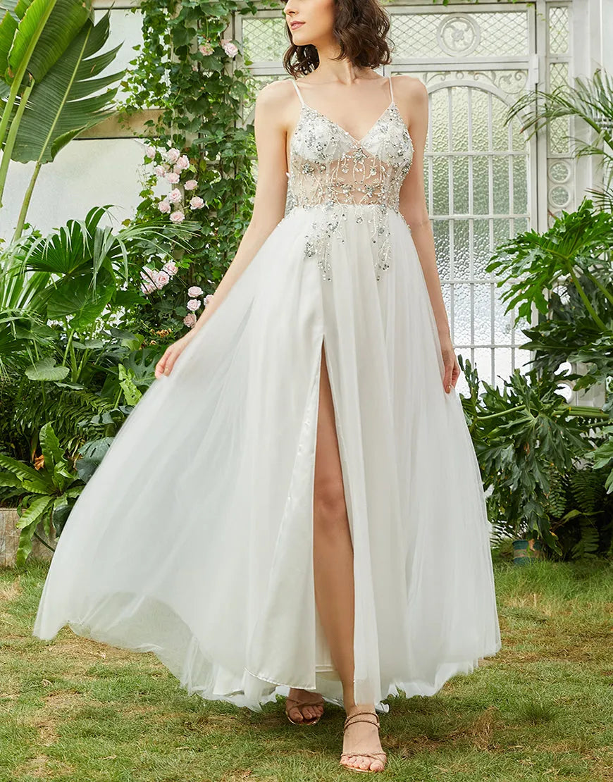 Elegant A-line long prom dress with spaghetti straps and beading details.