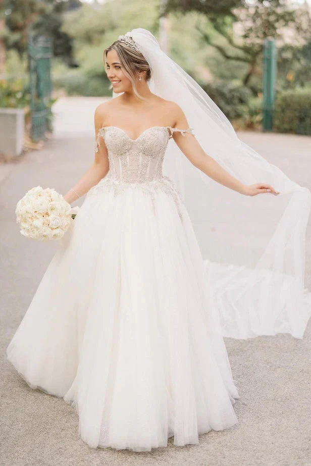 Elegant A-line sweetheart tulle wedding dress with intricate beading.