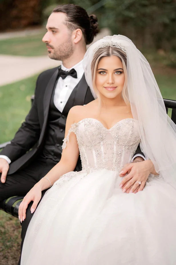 Close-up of the sweetheart neckline and sparkling beading on a tulle wedding gown.