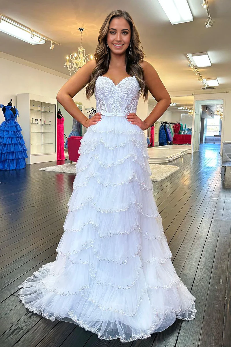 Elegant white A-line sweetheart prom dress with intricate beading and flowing tulle.