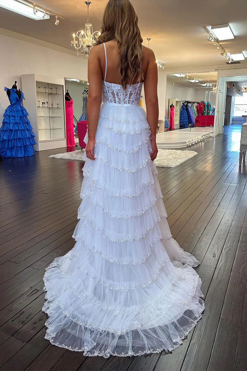 Close-up view of the beaded sweetheart neckline and delicate tulle fabric on a white prom dress.