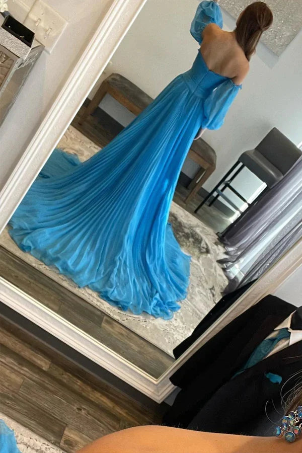 Side view of a flowing blue A-line prom dress, highlighting the long skirt and leg split.