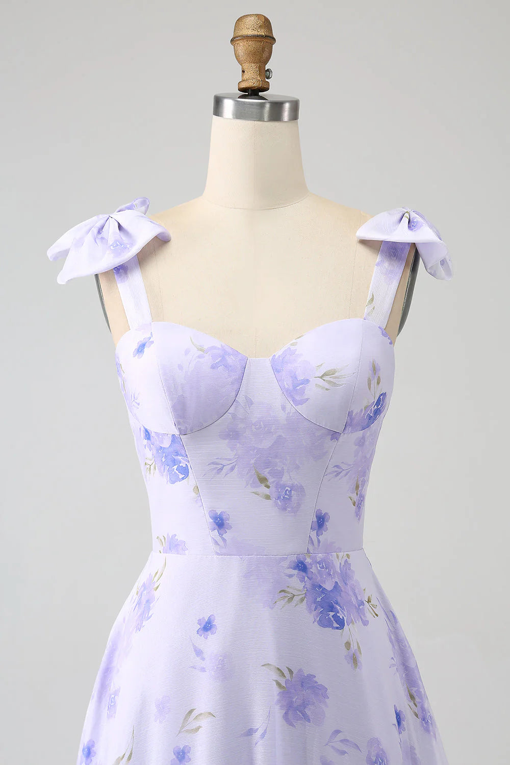 Close-up of the sweetheart corset bodice with intricate floral appliqués on the lilac prom dress.