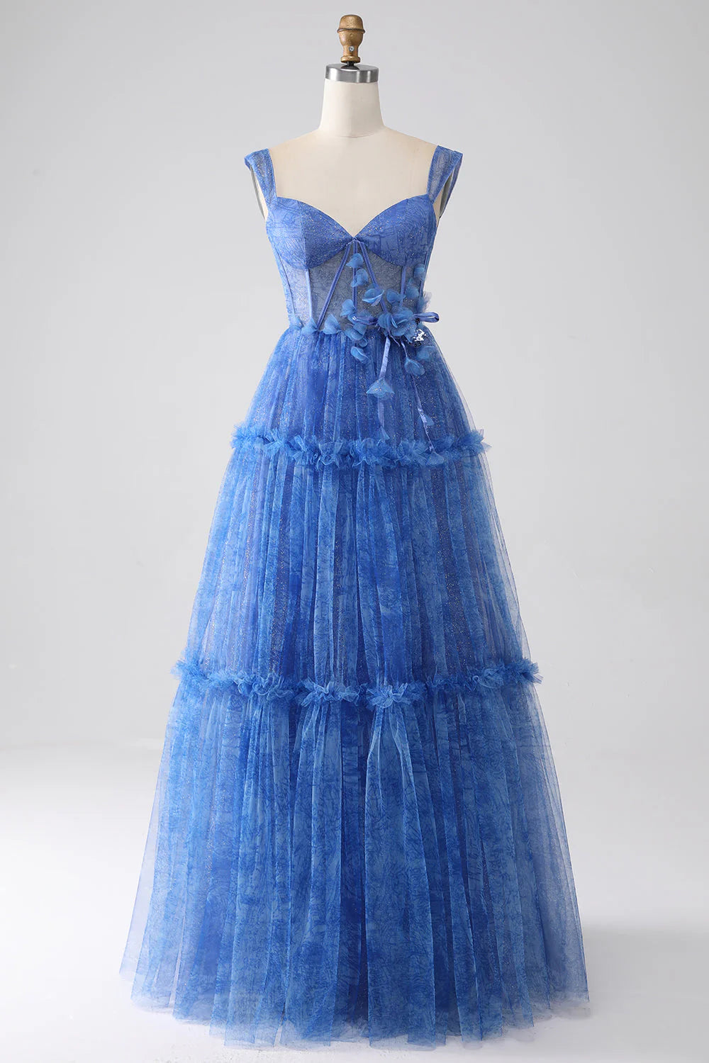 Model wearing a blue A-line tulle corset prom dress, front view.