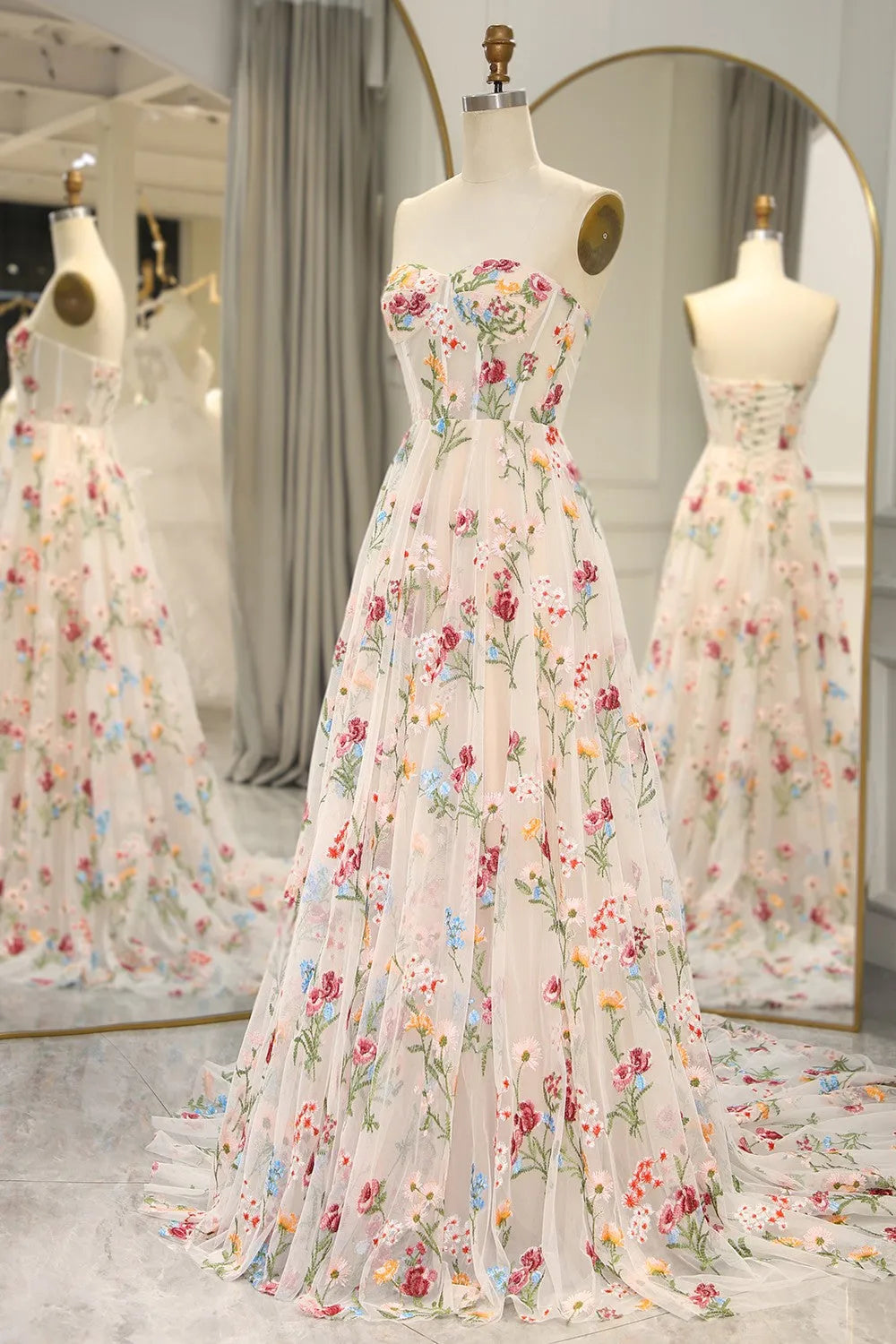 Close-up of delicate floral embroidery on the bodice of the ivory prom dress.