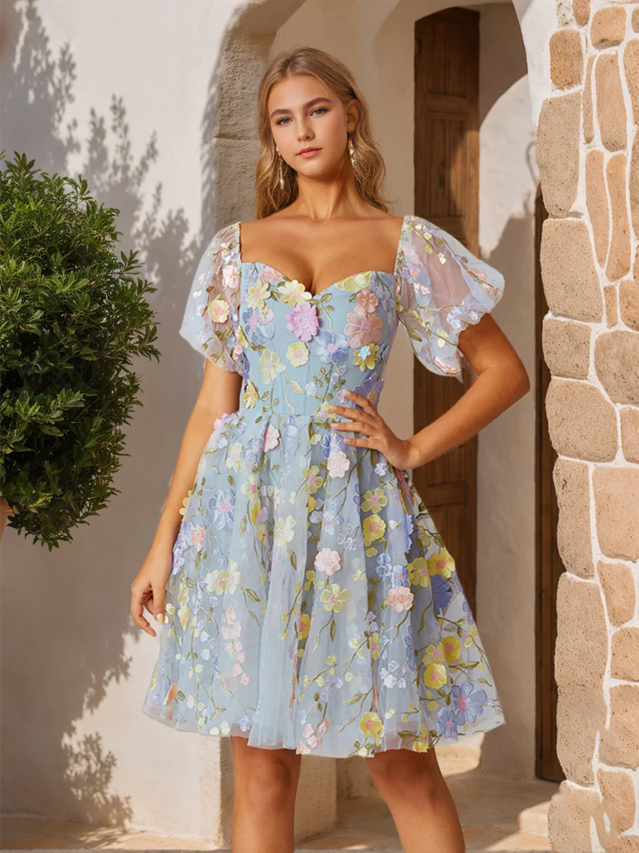 White A-line homecoming dress with sweetheart neckline and embroidery.