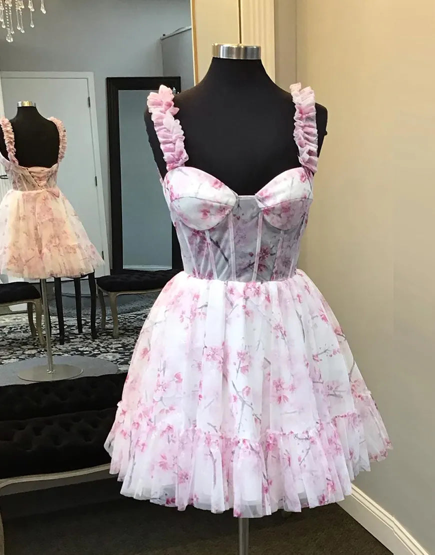 Pink A-line floral homecoming dress with ruffled straps and corset bodice.