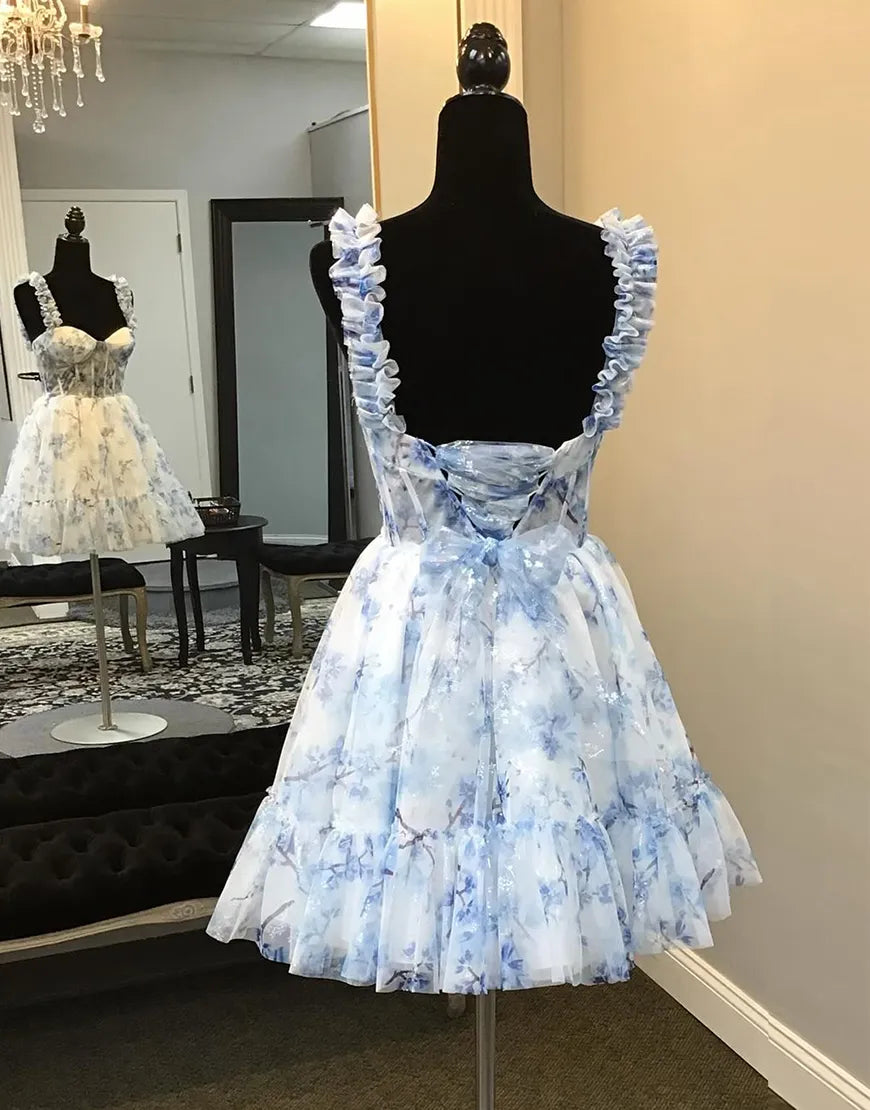 Blue A-line floral homecoming dress with ruffled straps and corset bodice.