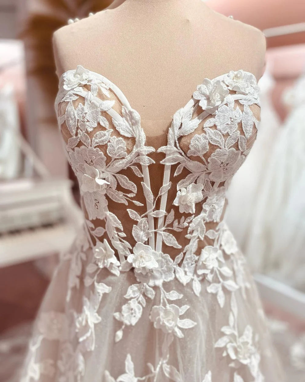 Close-up of sweetheart neckline and delicate tulle fabric on wedding dress.