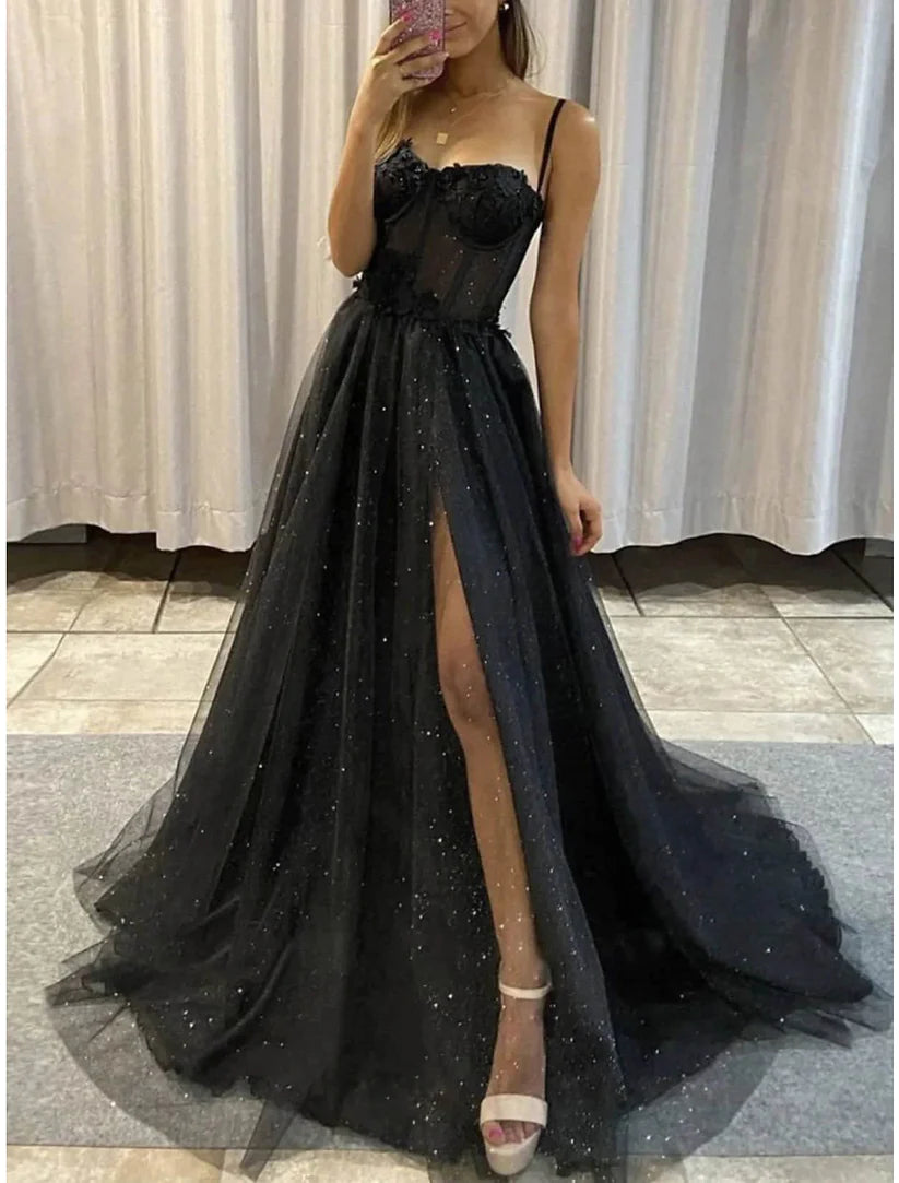 Close-up of the glitter tulle fabric on a black A-line dress.