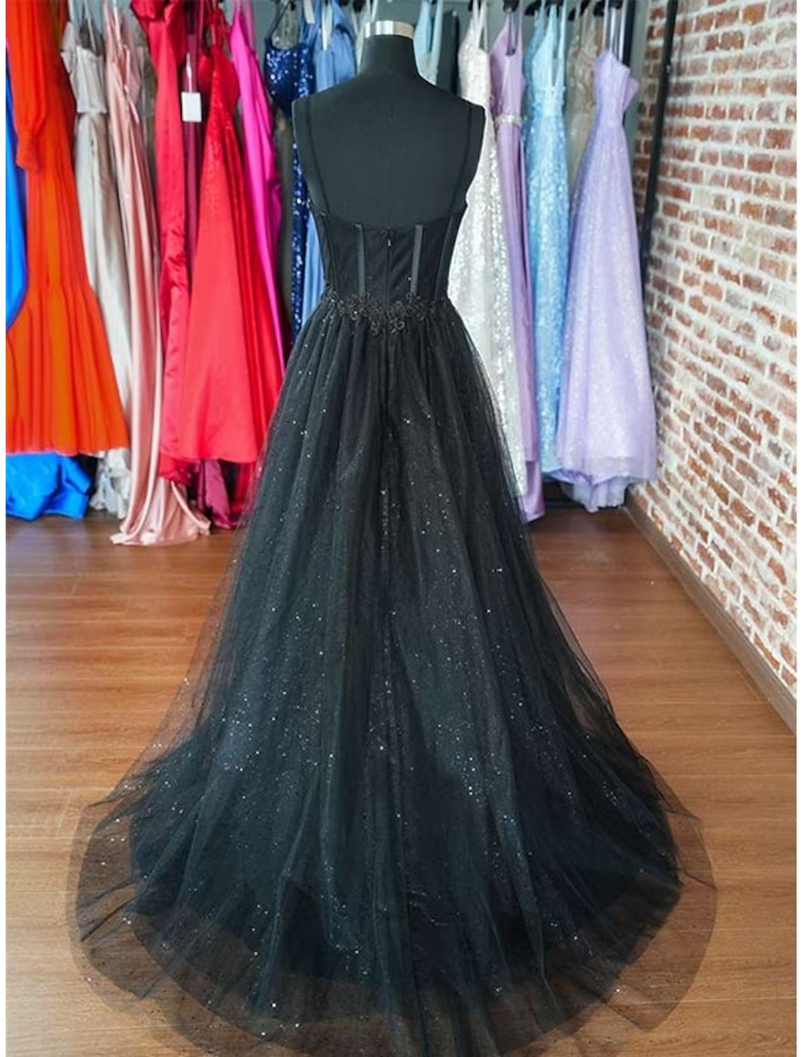 Back view of an A-line glitter tulle formal dress, showcasing the floor-length design.