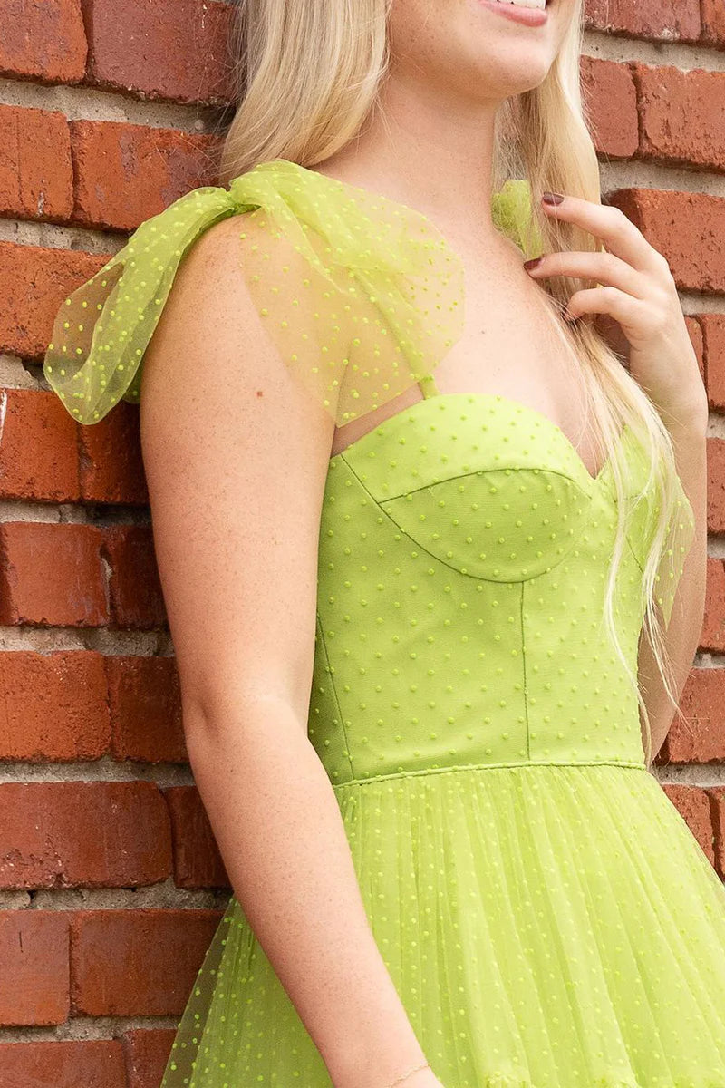 Close-up of the green dot tulle fabric and sweetheart neckline of the gown.