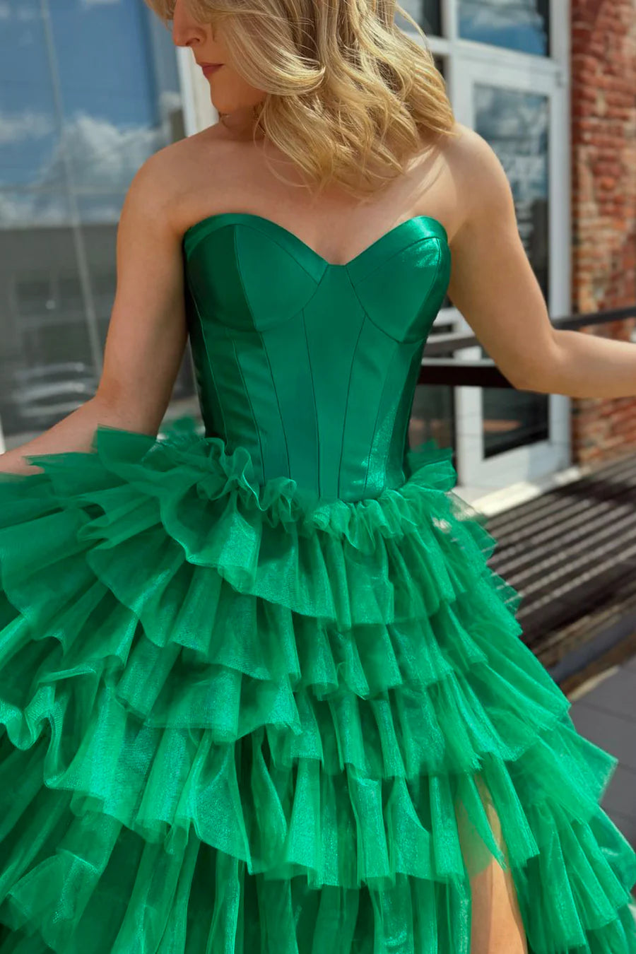Green tiered tulle formal gown with sweetheart neckline, side view.