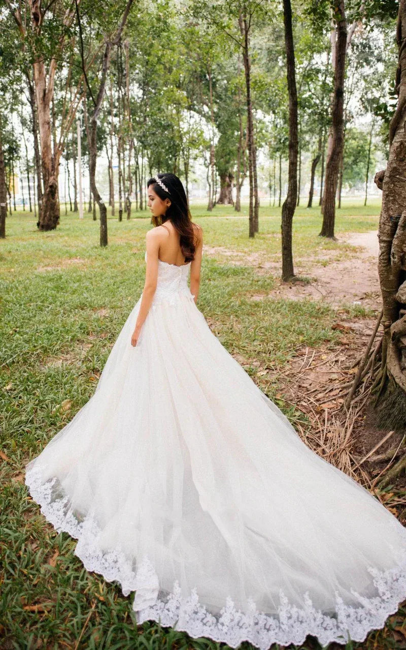 Back view of the formal A-line wedding gown with intricate lace details.