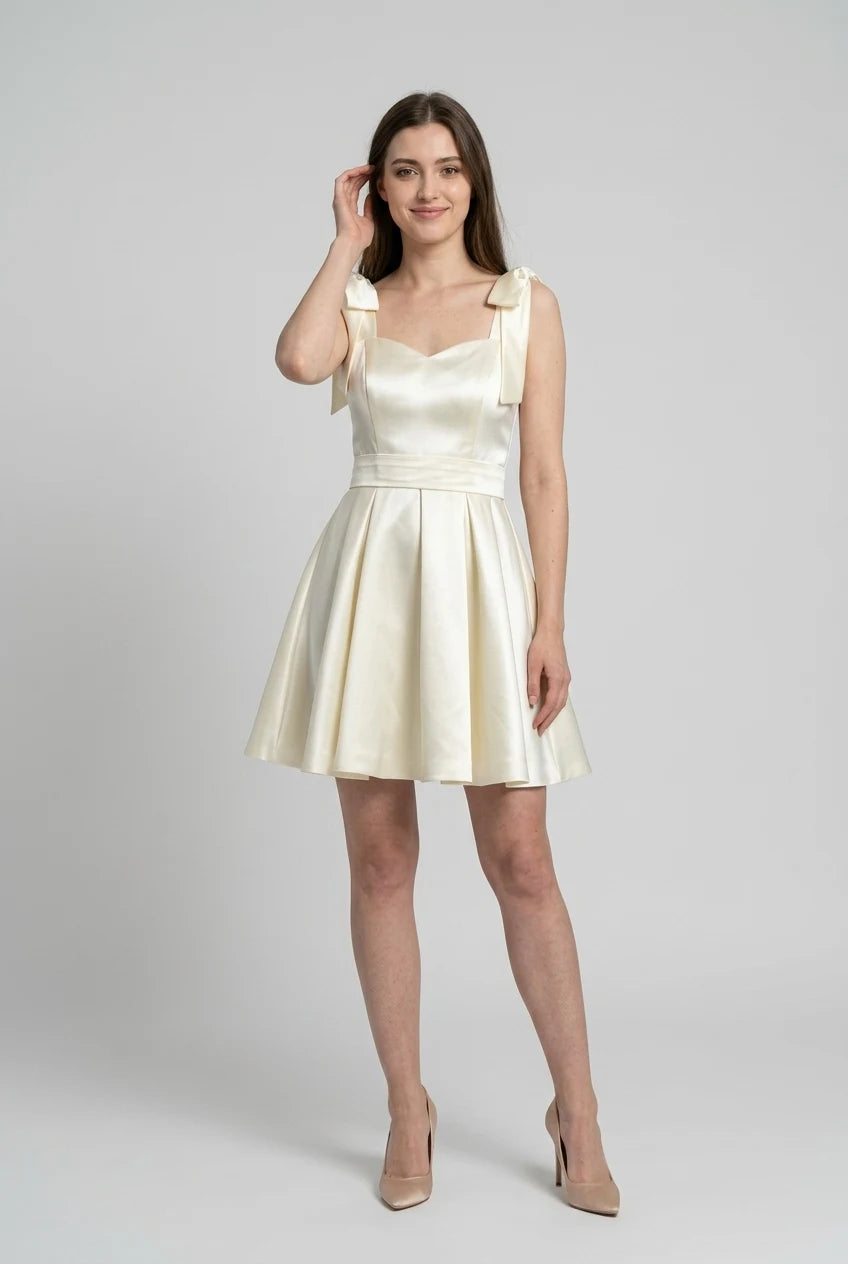 Back view of the ivory satin mini dress, highlighting the hidden zipper.