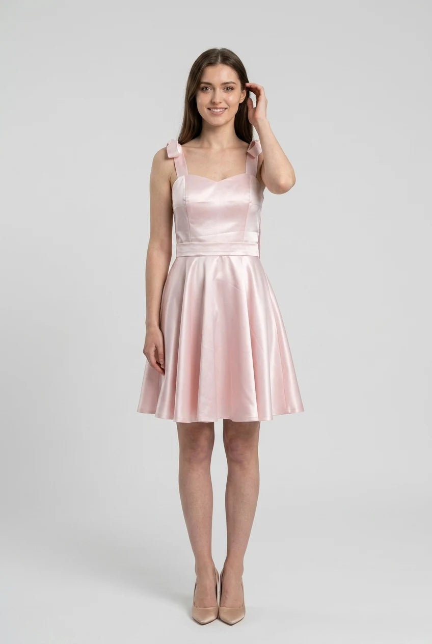 Close-up of the sweetheart neckline and bow shoulder straps on the ivory dress.