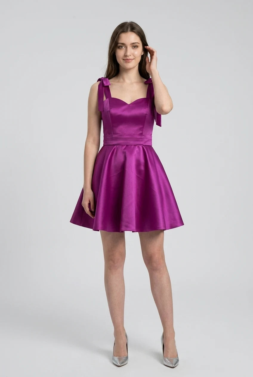 Ivory satin mini dress on a model, posing to show the full silhouette.