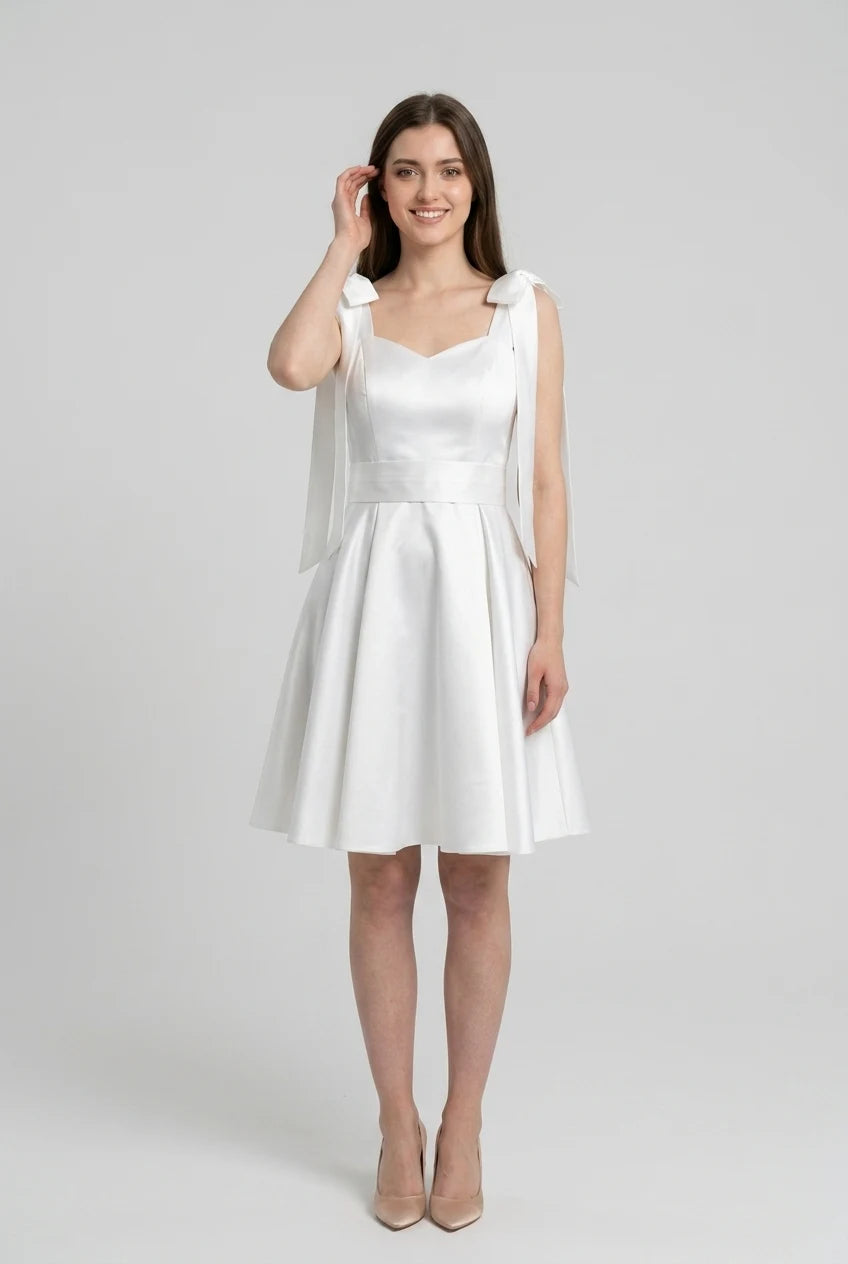 Front view of the ivory satin mini dress, emphasizing the glossy fabric.