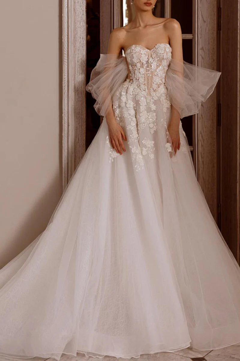 Elegant A-Line wedding dress with sweetheart neckline and lace appliques.
