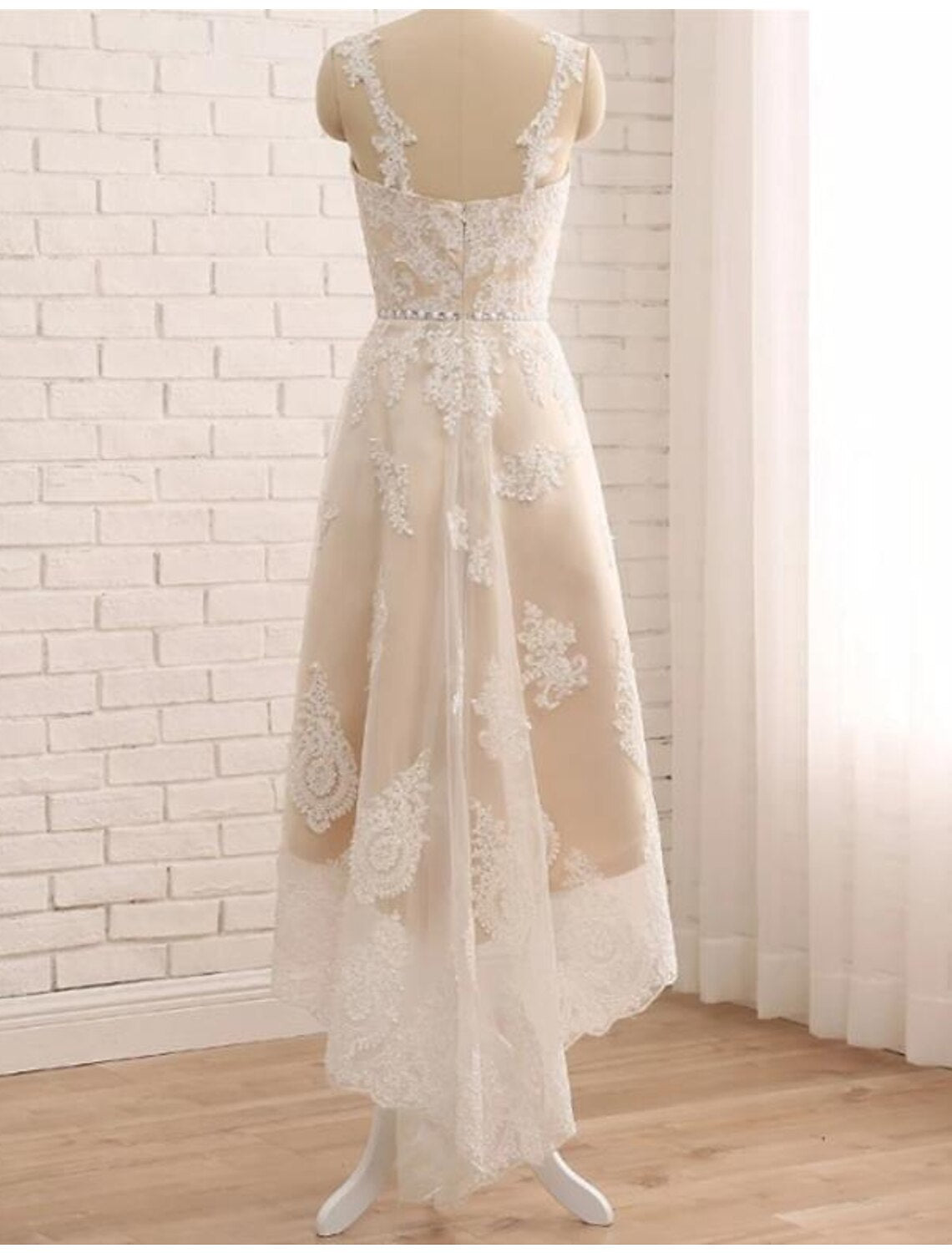 Model wearing an elegant A-line little white lace dress with a sweetheart neckline and regular straps.