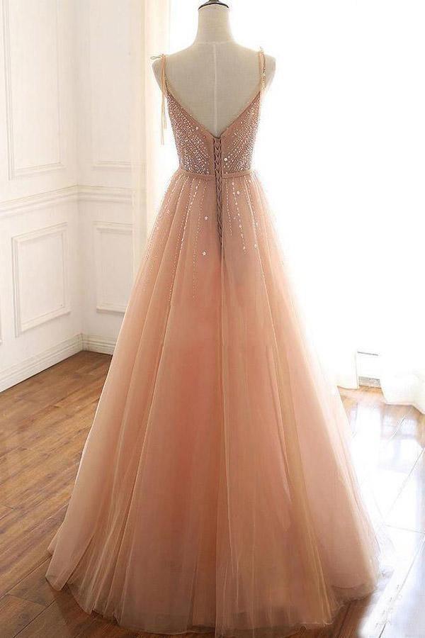 Back view of an A-line prom dress showcasing intricate lace detailing and flowing tulle skirt.