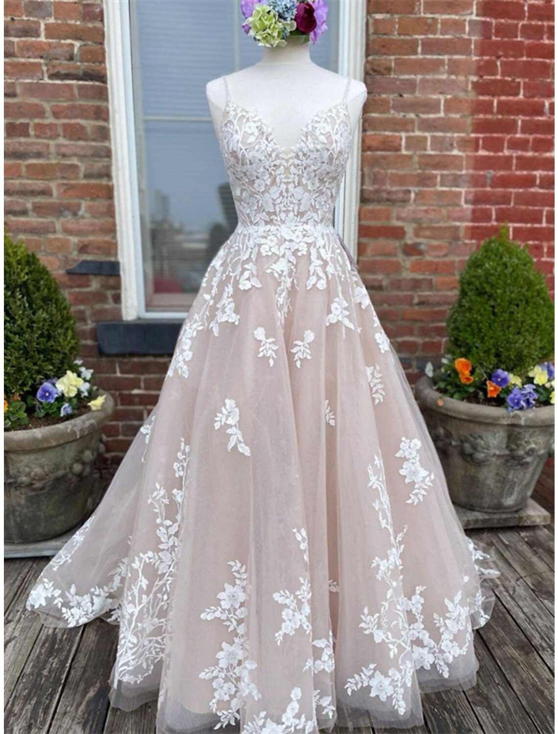 Elegant A-line wedding dress with sweetheart neckline, spaghetti straps, and lace appliques.