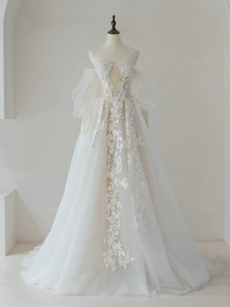 Model wearing an elegant A-line lace and tulle long prom dress.