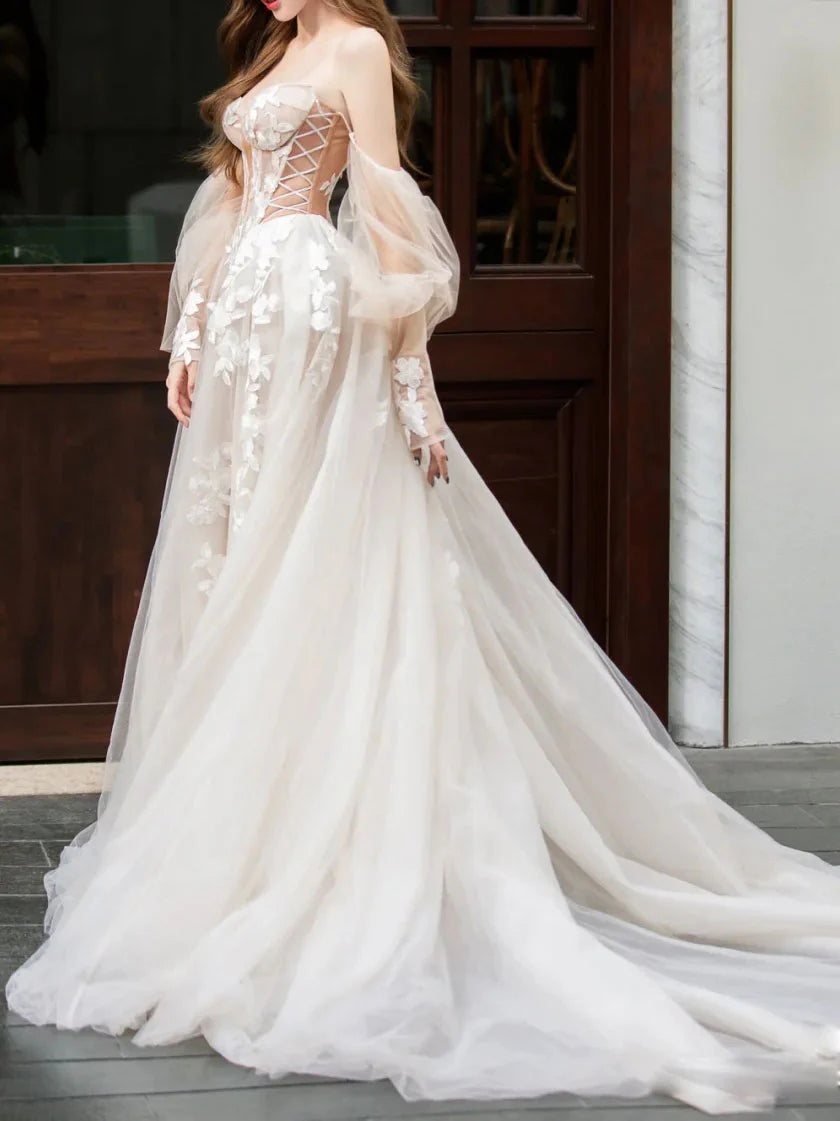 Side view of the flowing tulle skirt and lace details of the prom dress.