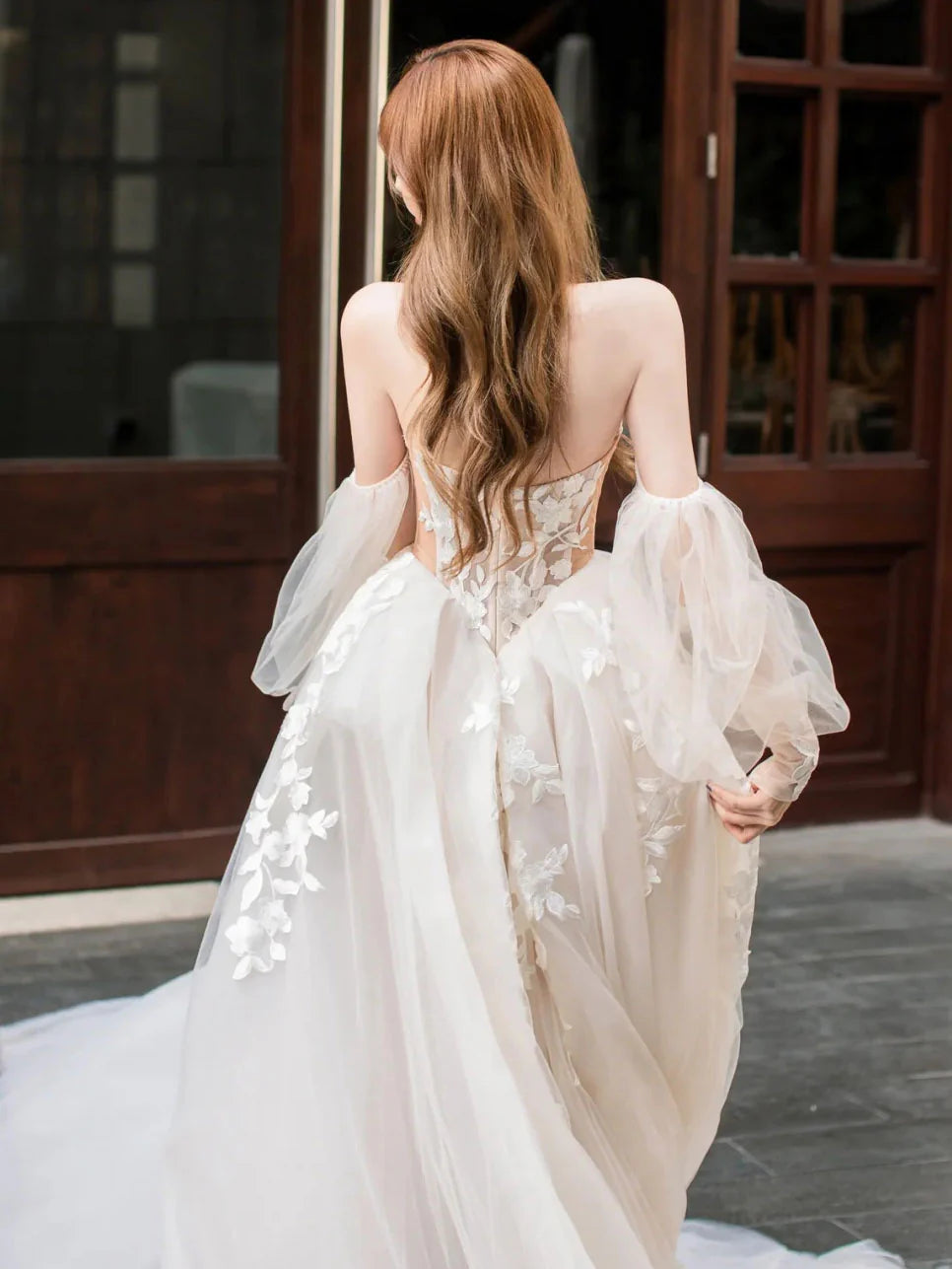 Model posing in the elegant A-line lace tulle long prom dress.