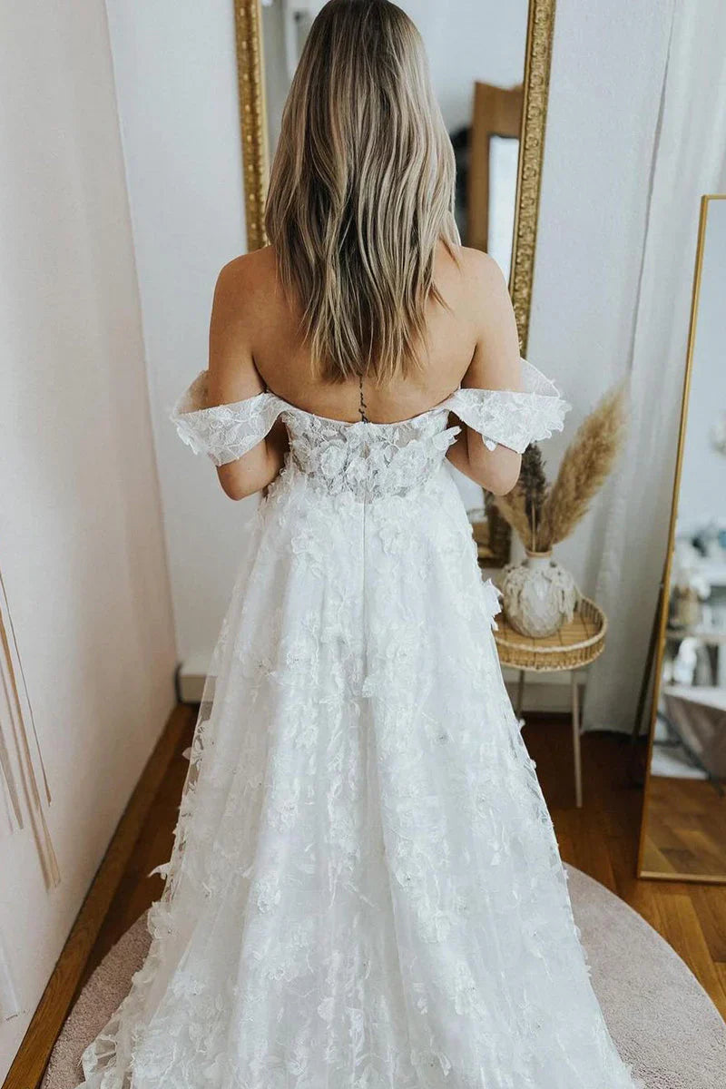 Back view of A-line lace wedding gown with straps, showcasing delicate fabric.