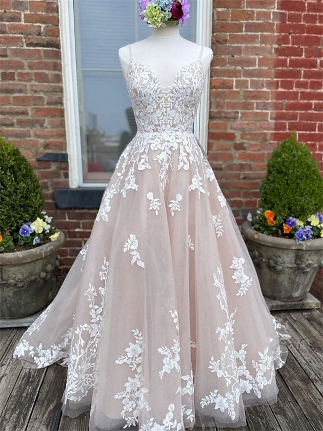 Elegant A-line white wedding dress with sweetheart neckline and spaghetti straps.