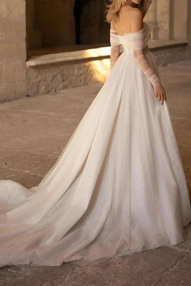 Back view of A-line wedding dress showing court train and long sleeves.