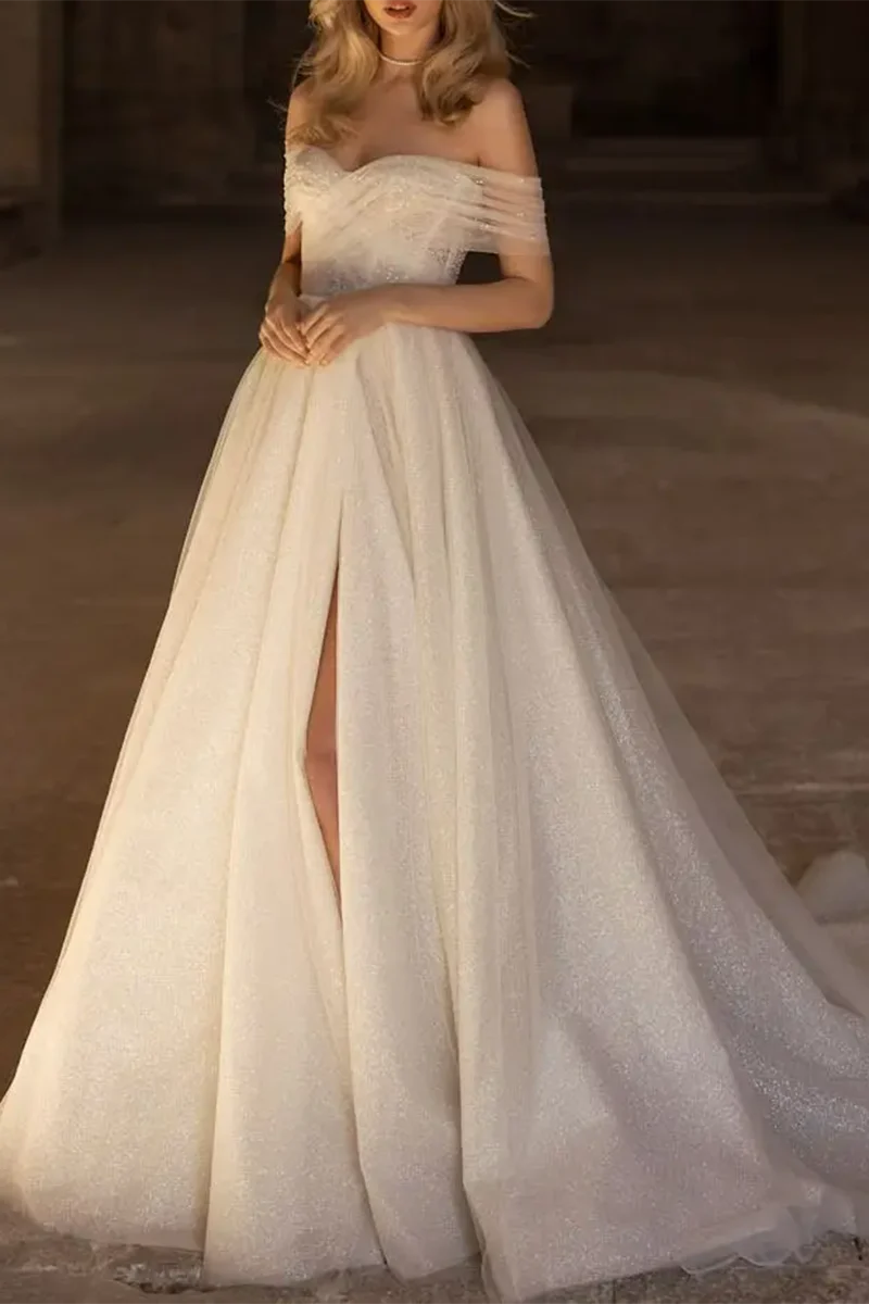 Bride in A-line wedding dress with sweetheart neckline and long sleeves.