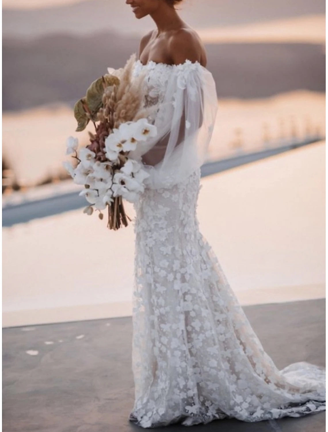 Back view of A-line wedding dress showing court train and lace details.