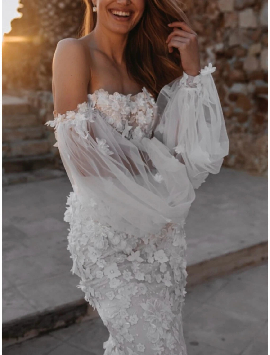 Close-up of intricate lace and applique details on a bridal gown.