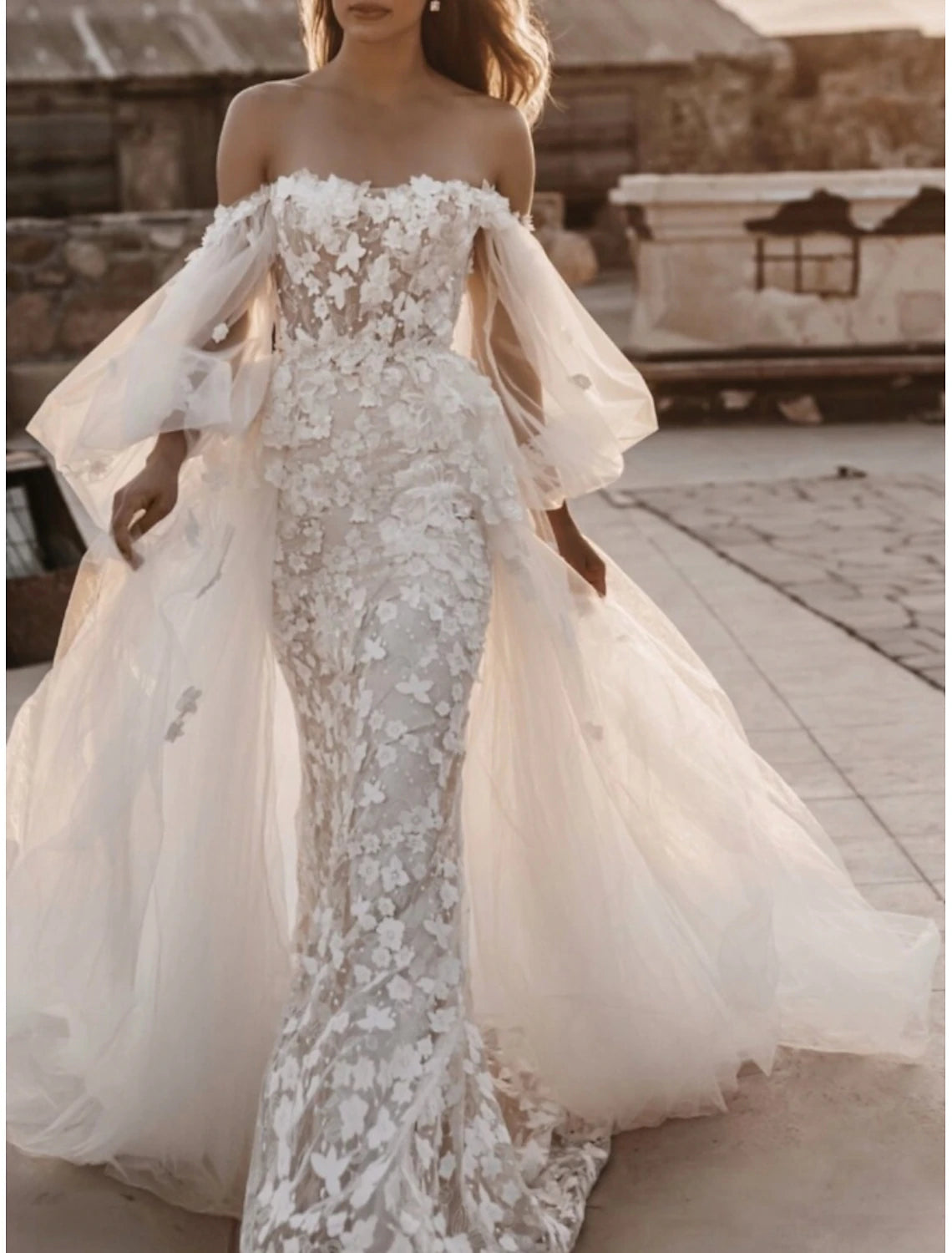 Side view of a formal A-line wedding dress with long sleeves.