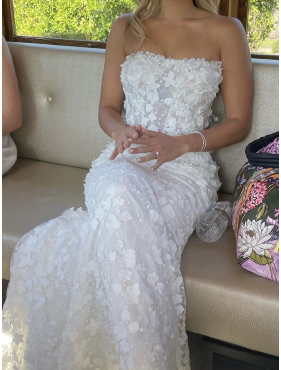 Full length view of a bride wearing a sweetheart long sleeve lace wedding dress.
